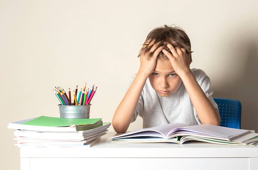 Image of a boy having trouble reading because of anxiety symptoms in children - Child Behavior Clinic